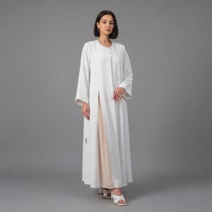 Embrace a new level of minimalist luxury with our Ivory Classic Abaya. This piece stands out with its clean architectural lines and unique asymmetric button fastening that adds a contemporary twist to the classic silhouette. Designed for the woman who loves "Quiet Luxury," it offers a bright, refreshing aesthetic perfect for daytime events, formal gatherings, or professional settings.