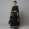 Make an unforgettable impression with our Black Cape Abaya, a masterpiece designed for the most prestigious occasions. This ensemble features a dramatic, floor-length cape overlay adorned with wide, intricate gold embroidery. The contrast between the deep onyx fabric and the radiant gold trim creates a regal silhouette that exudes confidence and timeless elegance.