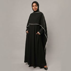 Redefine your modest style with our Black Cape Abaya, a perfect blend of functional design and playful sophistication. This unique piece features a stylish layered cape silhouette, accented with delicate white piping and charming polka-dot sleeves that add a touch of personality to a classic black ensemble. Designed for the modern woman on the go, it seamlessly combines comfort with a high-fashion edge.