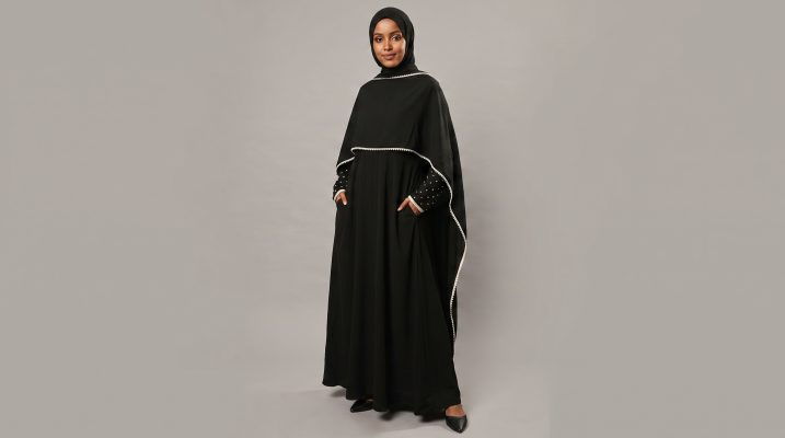Redefine your modest style with our Black Cape Abaya, a perfect blend of functional design and playful sophistication. This unique piece features a stylish layered cape silhouette, accented with delicate white piping and charming polka-dot sleeves that add a touch of personality to a classic black ensemble. Designed for the modern woman on the go, it seamlessly combines comfort with a high-fashion edge.