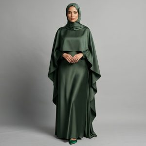 Make a regal statement with our Emerald Satin Cape Abaya. This piece is the definition of luxury, combining a deep, jewel-toned green with the liquid-like sheen of premium satin. The unique cape design adds a layer of sophisticated drama, making it the perfect ensemble for grand weddings, formal galas, and VIP celebrations.