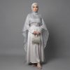 Make a breathtaking entrance with our Cape Abaya, a fusion of contemporary haute couture and traditional modesty. This exquisite piece features a dramatic, sheer shimmering cape that drapes elegantly over a smooth satin inner dress, creating a multi-dimensional look that captures the light from every angle. It’s the ultimate choice for the woman who wants to stand out at high-profile events.